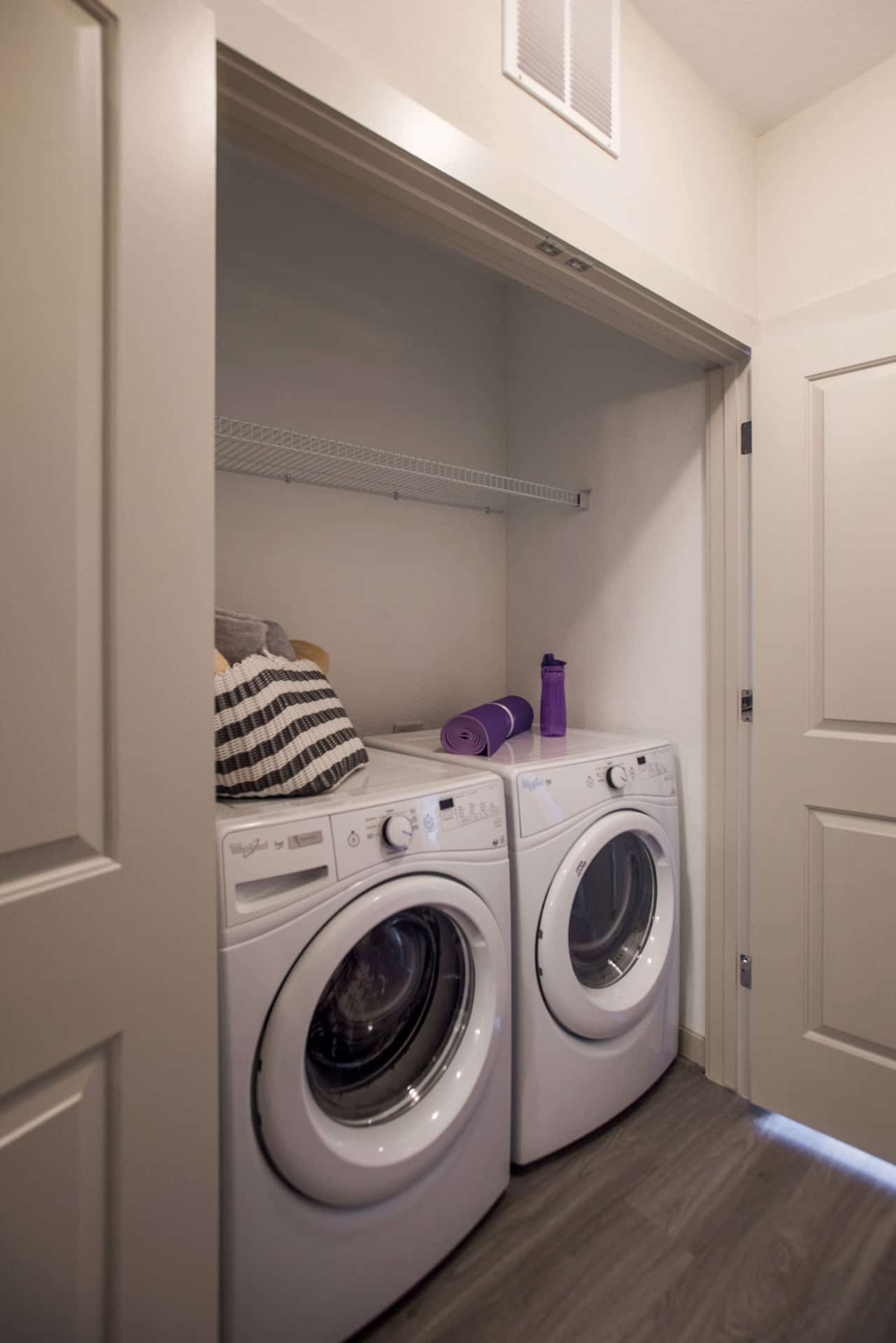 Closet with front load washer and dryer.