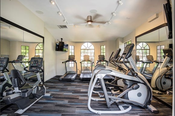 Gym with cardio equipment and mirrors