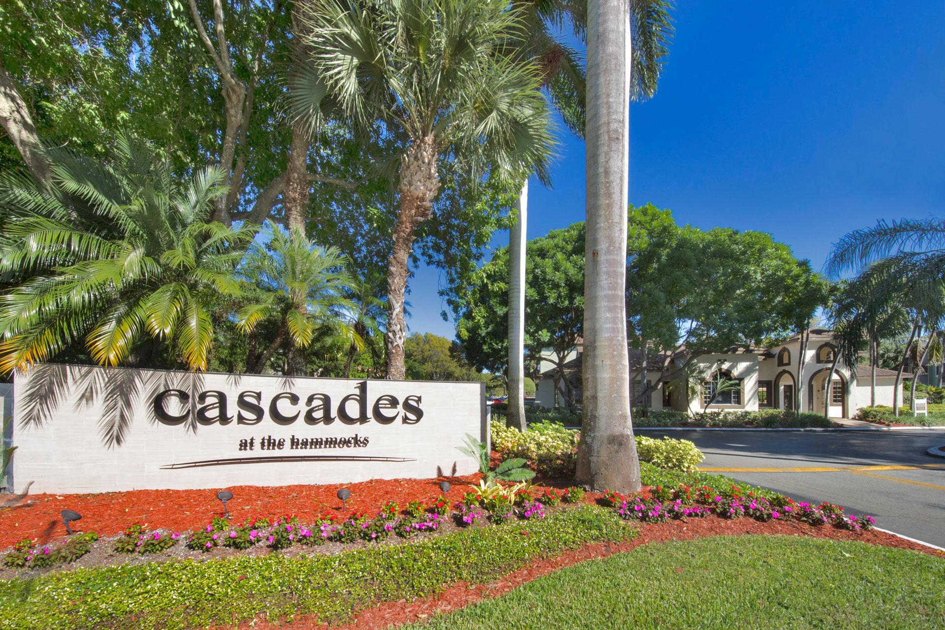 Exterior entrance sign with colorful landscaping.
