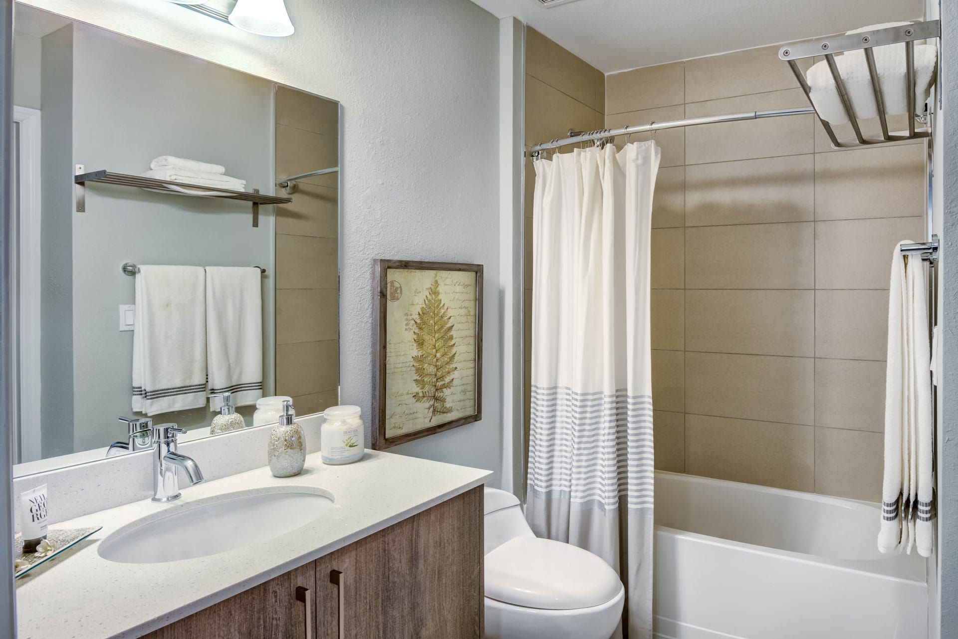 Bathroom with tub, beige tiles.