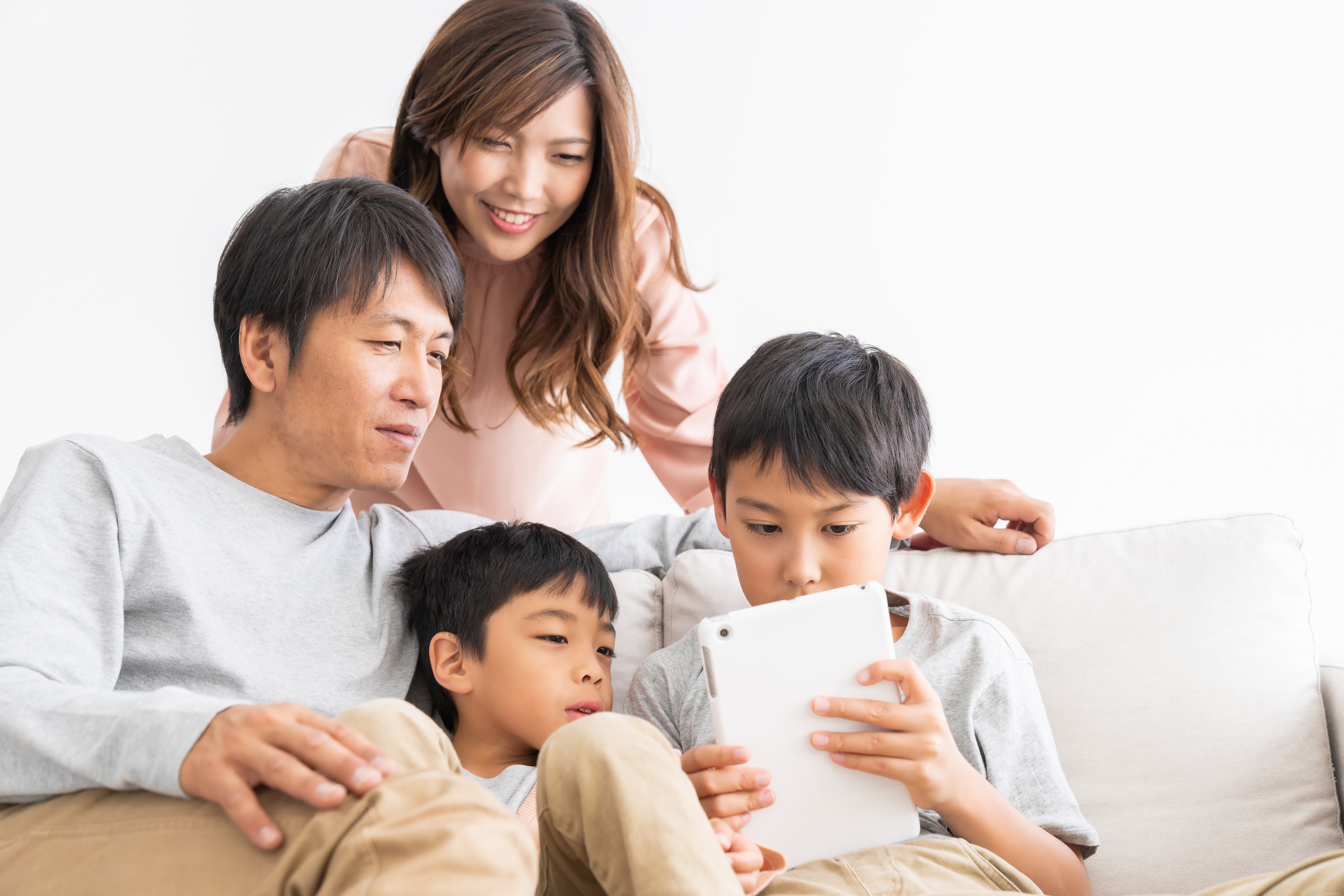 Family looking at apartments for rent on tablet computer