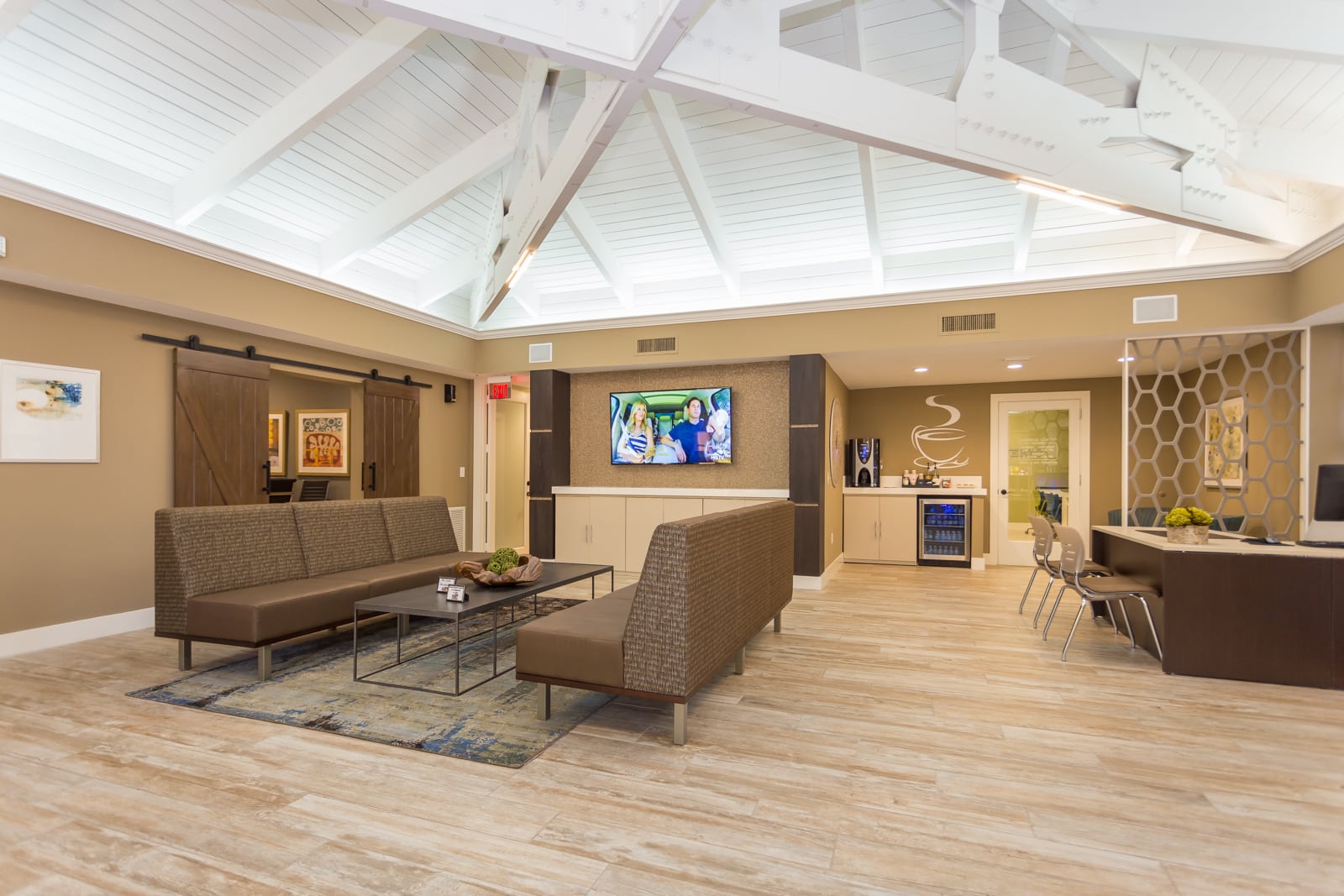 Resident clubhouse and leasing center with high vaulted ceilings.