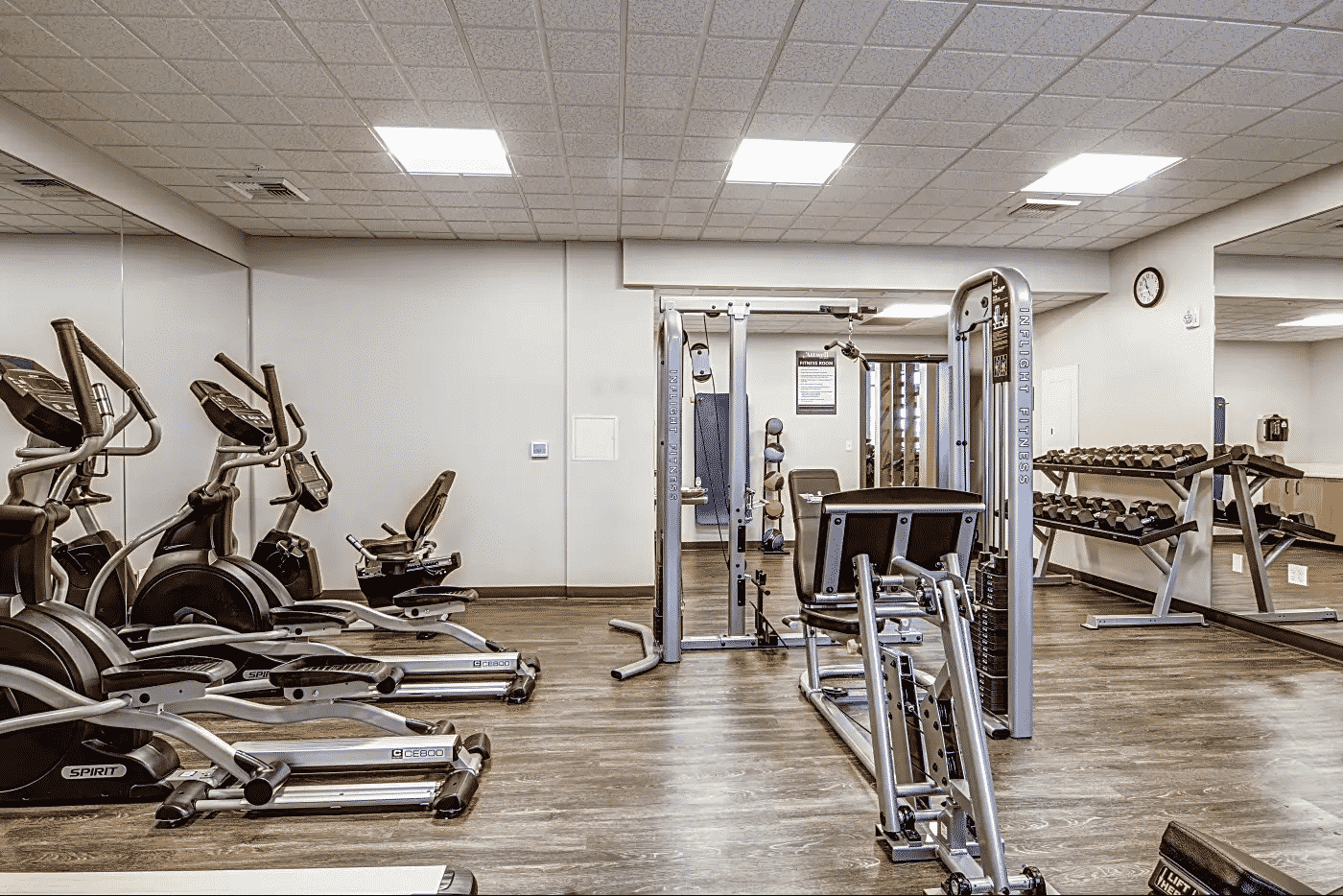 Fitness center with cardio machines and a few individual weight machines