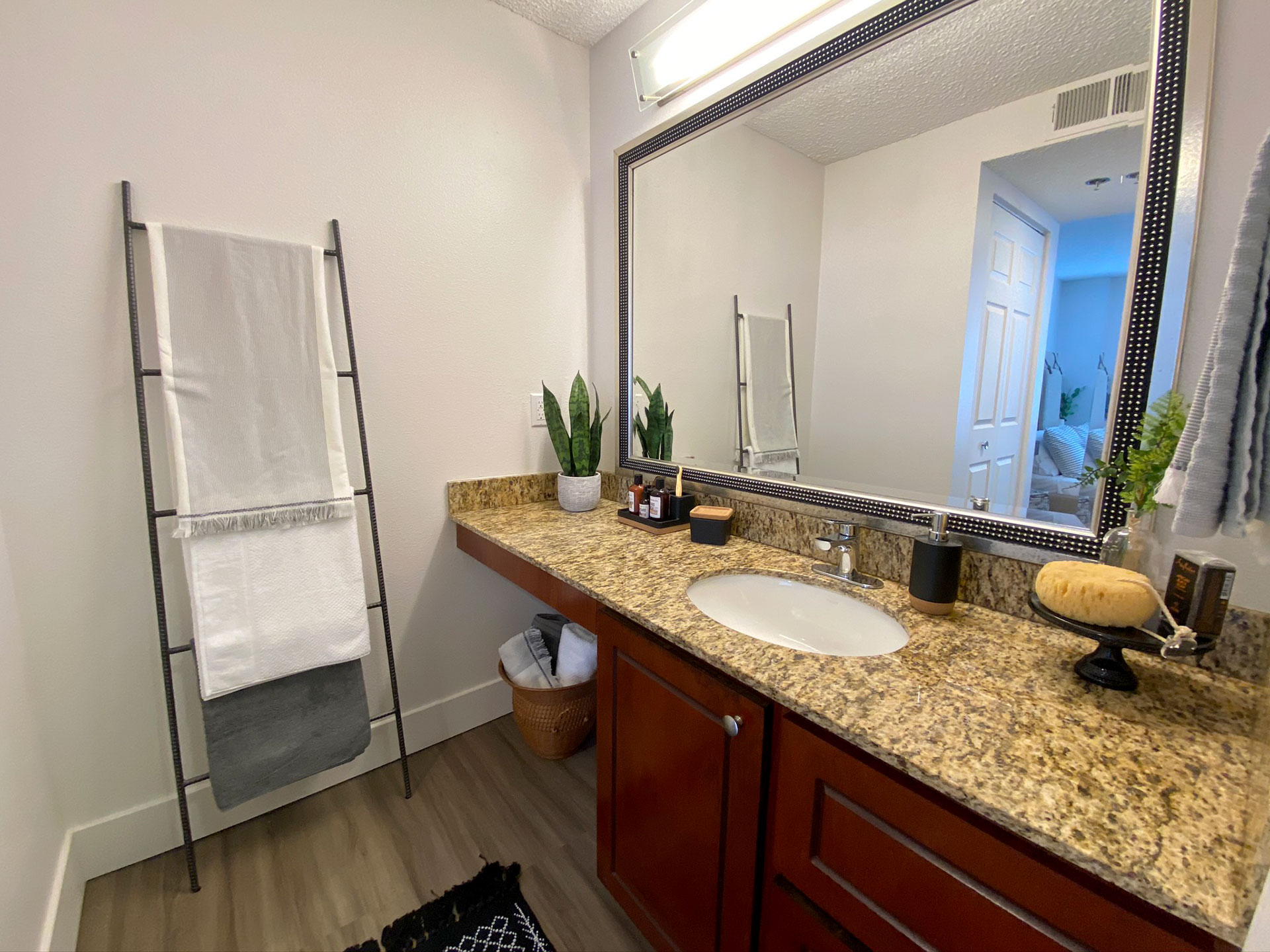 Long bathroom vanity with granite countertops.